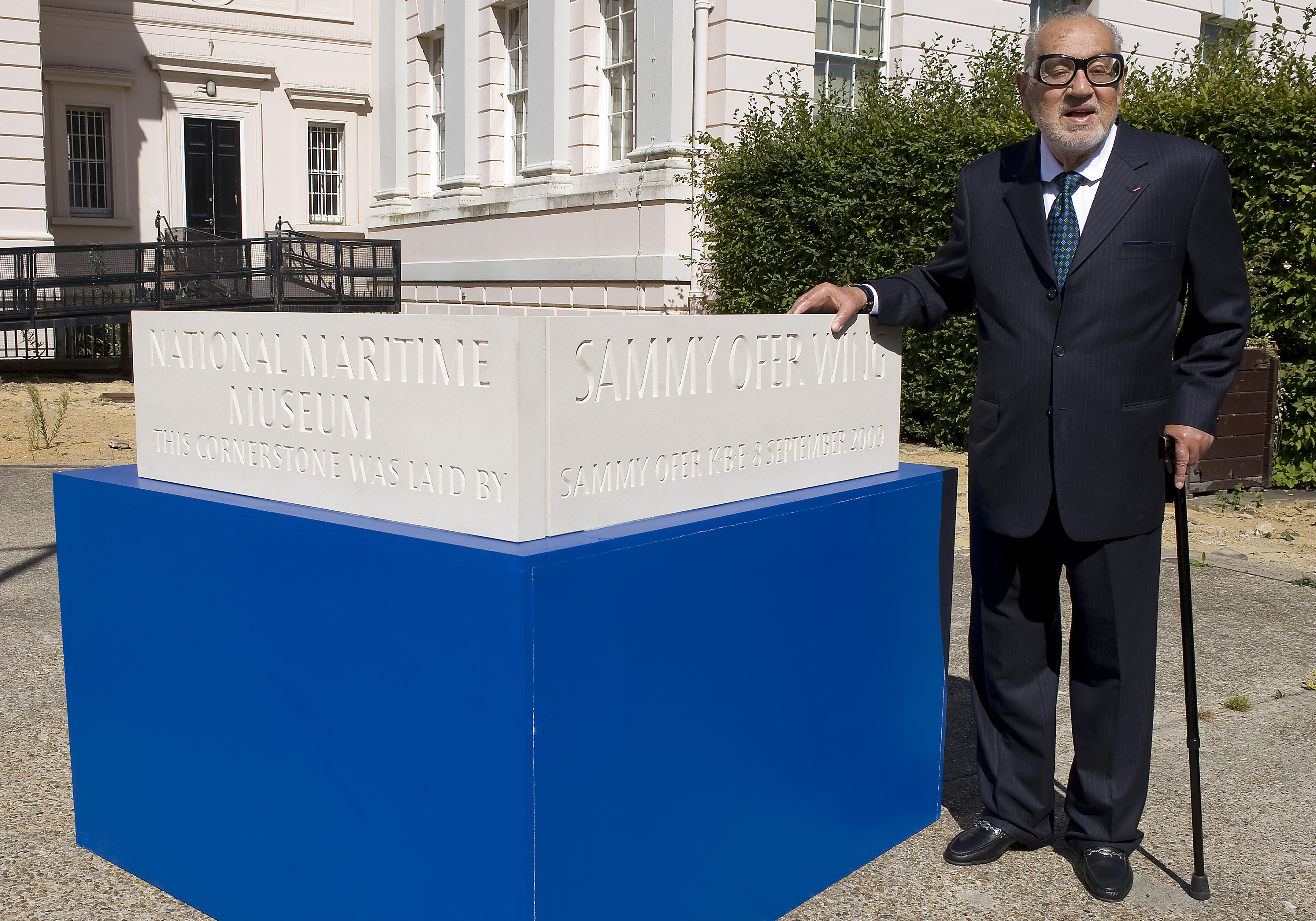 Sammy Ofer beside the cornerstone of the National Maritime Museum's Sammy Ofer Wing.